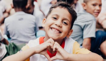 Ramacrisna's student smiling and making a heart format with his hands